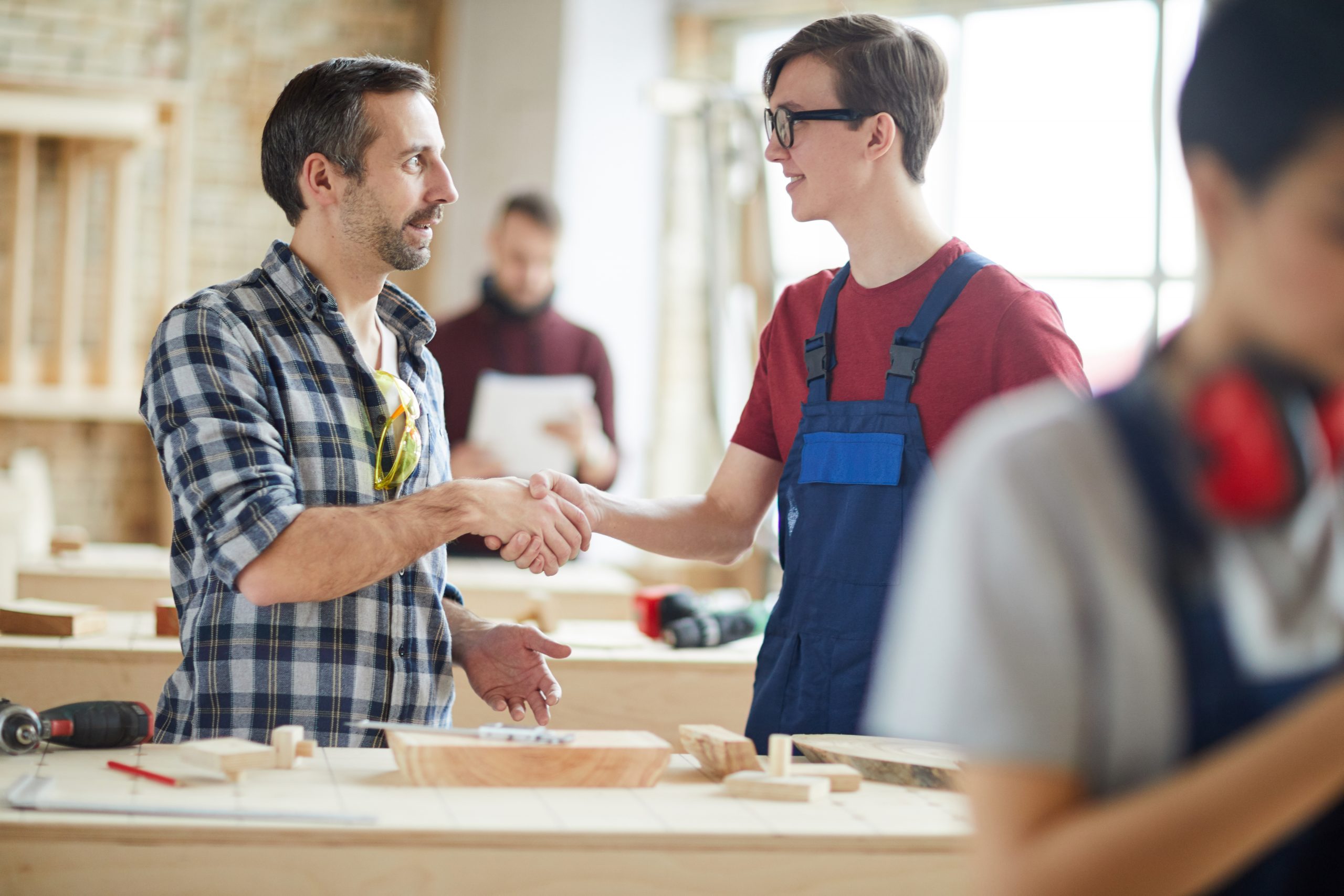 Worker Shaking Hands with Trainee